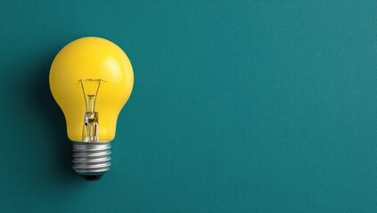 Single yellow lightbulb on teal background