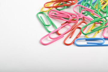 Pile of colorful paper clips isolated on white background
