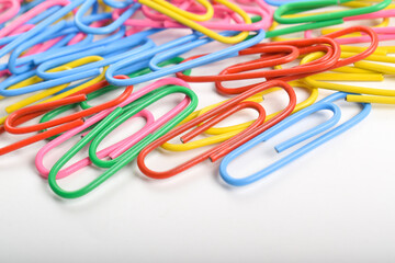 Pile of colorful paper clips isolated on white background