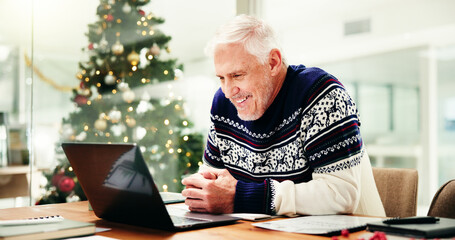 Mature man, laptop and Christmas at office with smile for review, proposal or festive sweater at company. Person, computer and happy in xmas jersey for results, feedback or project at creative agency