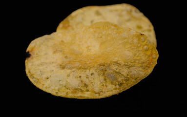 One single fried fatty potato chip with salt
