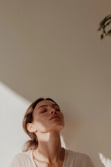 Woman with closed eyes in soft light undergoing advanced skincare procedure with digital facial markers