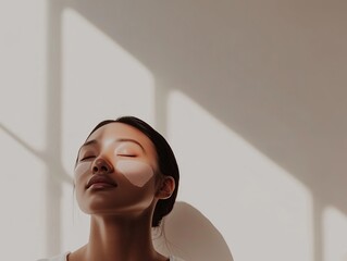 Woman with closed eyes and adhesive facial patches in sunlight, capturing a peaceful skincare and self-care moment
