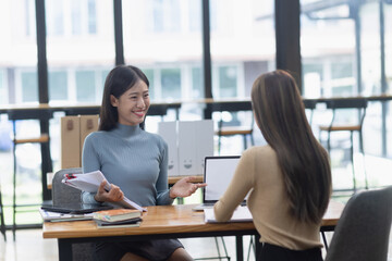 Two Asian young businesswoman using laptop computer working in office,