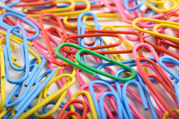 Pile of colorful paper clips on white background