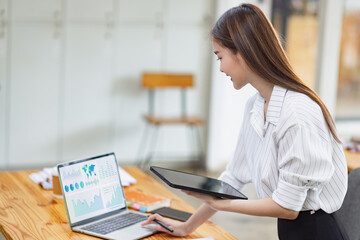 woman working on laptop computer with analysis data plan business strategies in office, Business discussing and startup concept.