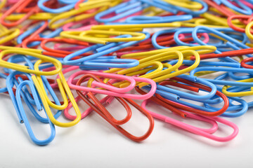 Many colorful paper clips isolated on white background