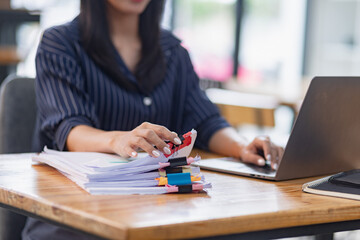 office worker woman working with documents on the desk in office.
