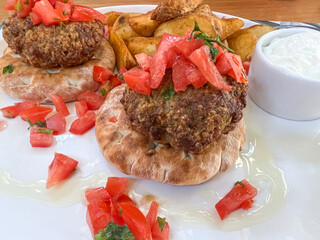 Mediterranean Meat ball Patties on Pita Bread, Tomato Topping and Yogurt Sauce