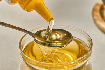 pouring honey into a glass