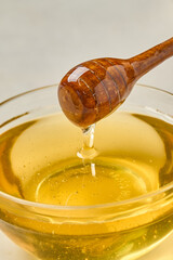 honey dripping from a wooden spoon