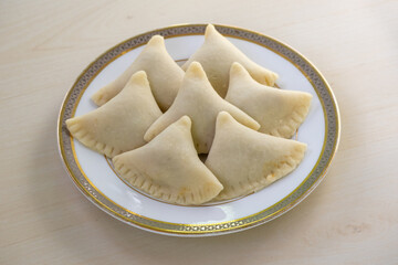Delicious Beef Samosas ready to fry. Perfect for Ramadan Iftar. Authentic Bangladeshi, Indian, Pakistani cuisine. Tasty homemade spicy sanbusak, sambosas, samsa.