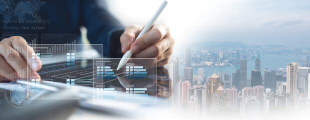 Finance analyst using digital tablet analyzing sales data and financial growth graph chart report,...