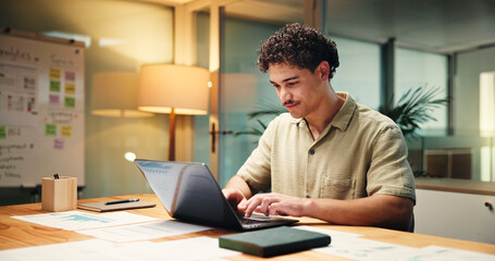 Business, man and laptop in office at night of accounting, finance report and budget review....
