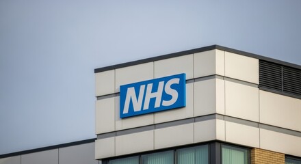 Close-up view of an NHS sign mounted on a building's exterior, showcasing the organization's branding.