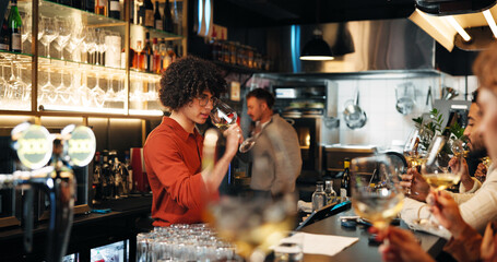 Wine tasting, alcohol and waiter with glass in restaurant for customer service, order and hospitality. Nightclub, pub and bartender with drinks, beverage and liquid for serving people in happy hour