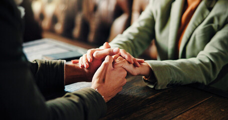 Holding hands, love and couple in coffee shop on date in morning with bonding, support or care....