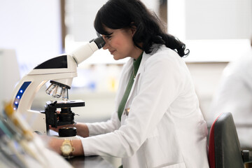 Doctor scientist using microscope in laboratory