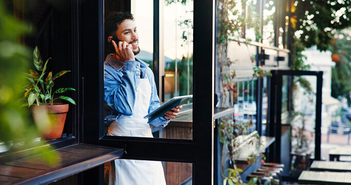 Entrance, phone call and tablet with man in coffee shop for hospitality, online order or service. App, communication and smile of waiter in doorway of cafe or restaurant for small business management - Powered by Adobe