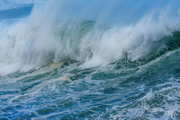 Obraz premium Powerful ocean waves crash along the Hermanus shoreline after a dramatic winter storm, capturing the raw energy and beauty of nature on the Whale Coast, Overberg, Western Cape, South Africa.