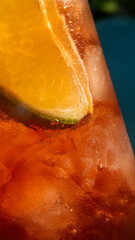 Citrus slice clings to frosted amber nectar, evoking summer solstice celebrations and playful...