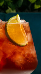 Sun-kissed citrus slice adorns vibrant iced sunset cocktail, invoking National Margarita Day and the vibrant Las Fallas festival