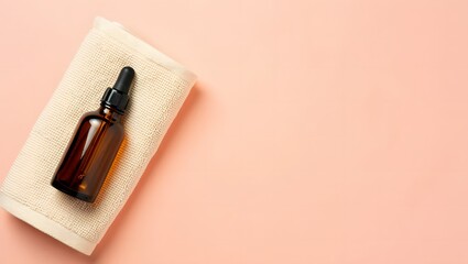 Amber Glass Dropper Bottle and Cream-Colored Towel on Peach Background: Minimalist Skincare Product Mockup