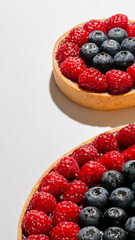 Round tart brimming with sunlit raspberries and blueberries, a symphony of flavors for Bastille Day or Midsummer Feast
