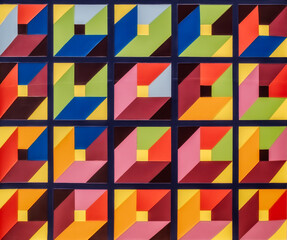 geometric mosaic artwork featuring a repeating pattern of interlocking triangles, arranged in a grid-like structure. The mosaic tiles creating a vibrant and eye-catching visual effect