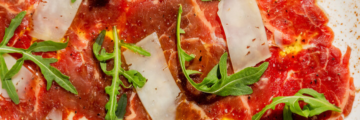 Peppery arugula pirouettes atop marbled horse carpaccio symphony, invoking Renaissance feasts and midsummer Italian festas with vivid culinary exuberance © fotoworld
