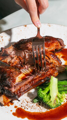 Sizzling barbecue ribs glisten with tangy glaze, captured at Indigenous Peoples' Day feast, evoking...