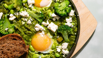 Sunny eggs nestle in a verdant forest of broccoli, evoking Earth Day brunch and World Vegetarian Day indulgences