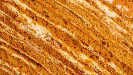 Golden honey cake slices resemble geological strata, evoking Harvest Festival and World Baking Day's sweetly layered indulgence