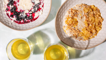 Sunlit winter solstice breakfast, vibrant porridge bowls with berry symphony and golden granola, celebrating Imbolc and Hygge comforts