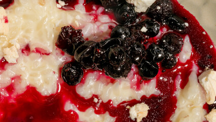 Succulent crimson berry drips swirl on creamy rice pudding evoke Yuletide indulgence, Nordic Midsummer feast, and culinary artistry