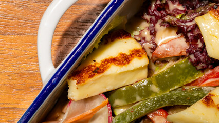 Grilled halloumi dances with vivid peppers in an earthy mosaic, celebrating Cyprus' Green Monday...