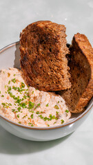 Rustic rye toast nestled in velvety cottage cheese, chive whispers; perfect companion for Hygge brunch or World Bread Day