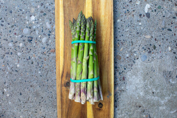 Bundle of fresh asparagus spears tied with bands, reminiscent of Medieval Harvest Feast, whispering...