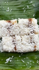 Kue Putu, Indonesian Traditional Cake Made from RIce Flour, Palm SUgar, Pandan Leaf, and Shredded Coconut. Come with Cylinder Shape with Bamboo Pipe