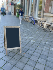 empty or blank black announcement chalkboard at street.	
