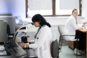 Doctor scientist using microscope in laboratory
