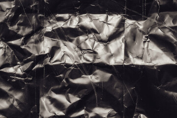 crumpled paper background with scratch dust and light leaks,retro grain noisy film distressed texture light leak flare on black background