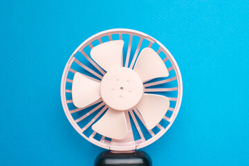 Pink Portable Fan on Vibrant Blue Background for Summer Cooling