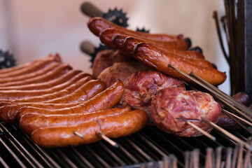 Sausages and meat on a grill