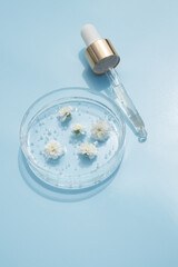 Dropper glass branding mockup. Cosmetic pipette. Trendy blue background. Concept of organic and...