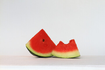 Two slices of watermelon on white background.