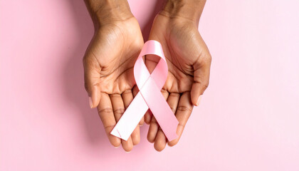 woman holding a pink ribbon, breast cancer awareness month