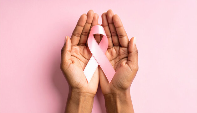 woman holding a pink ribbon, breast cancer awareness month