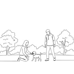 Young couple playing with their dog in the park on sunny day  