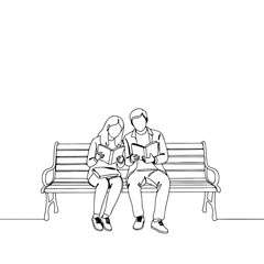 Couple reading books together while sitting on a park bench  